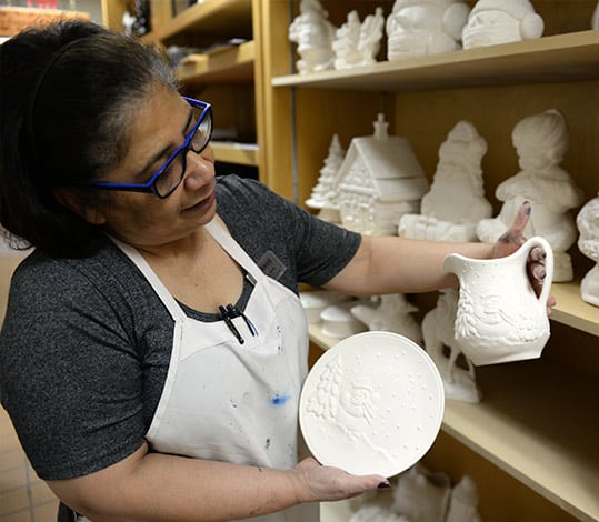 Women looking at pottery